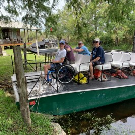 a group of people riding on the back of a boat