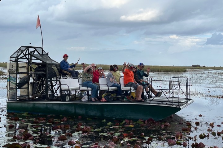 a group of people in a boat on a body of water