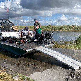 a group of people sitting at a dock