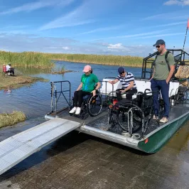 a group of people sitting at a dock