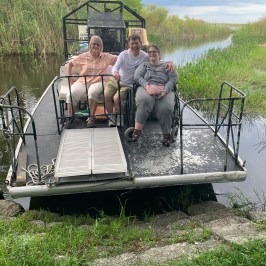 a group of people sitting on a bench in a park
